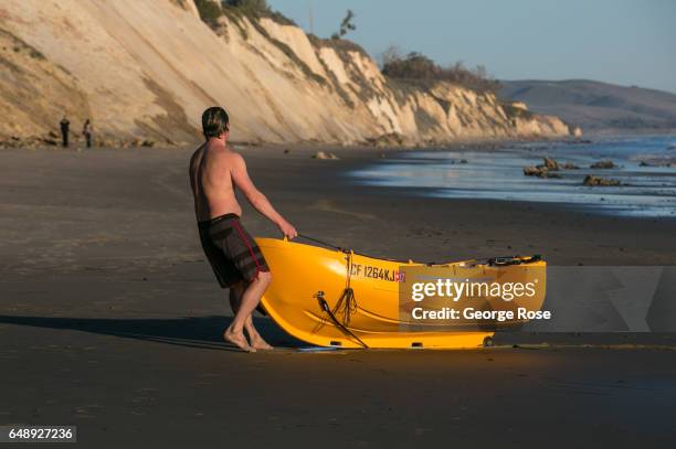 Man drags his small fishing boat onto the sand at Gaviota Beach on December 28 in Gaviota State Park, California. Because of its close proximity to...