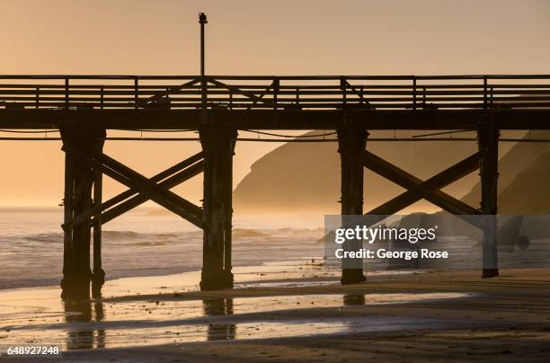 The abandoned pier is silhouetted against a setting sun on December 28 in Gaviota State Park, California. Because of its close proximity to the...