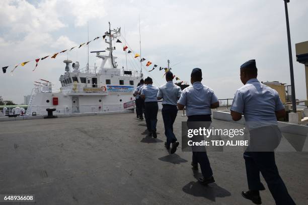 Philippine coast guard personnel run towards the newly commissioned coast guard's Multi-Role Response Vessel BRP Malapascua during a ceremony at the...