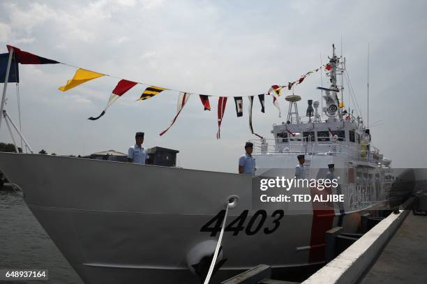 Philippine coast guard stand on the newly commissioned coast guard's Multi-Role Response Vessel BRP Malapascua during a ceremony at the coast guard...