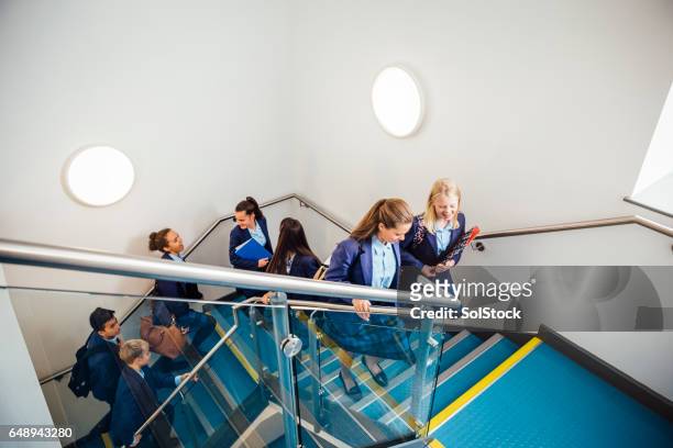 school children walking up school staircase - school uniform stock pictures, royalty-free photos & images