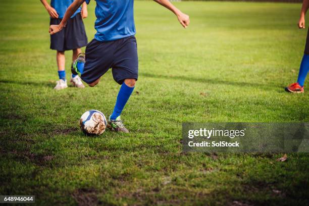 kicking a soccer ball - sports league stock pictures, royalty-free photos & images