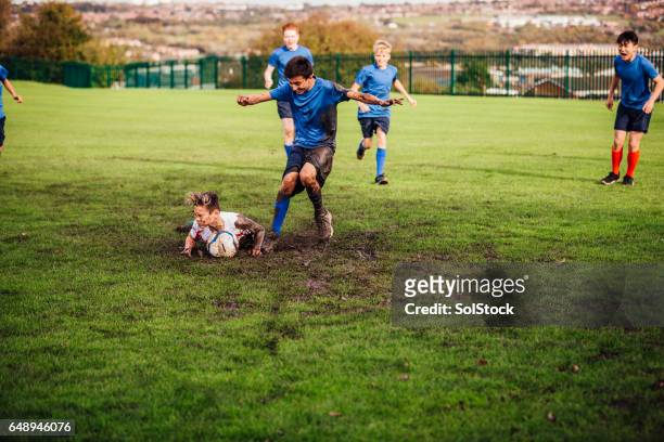 soccer player tackled down - tackling stock pictures, royalty-free photos & images