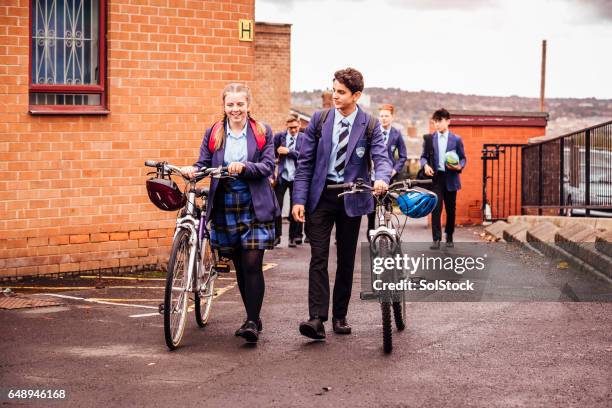 hon cyklar till skolan och tillbaka - school uniform bildbanksfoton och bilder
