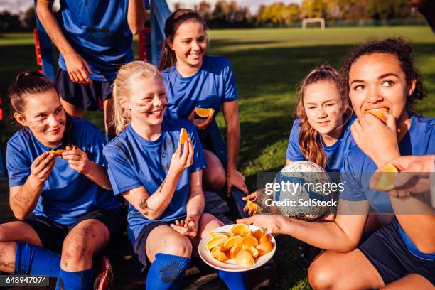 some vitamin c after training - kids eating stock pictures, royalty-free photos & images