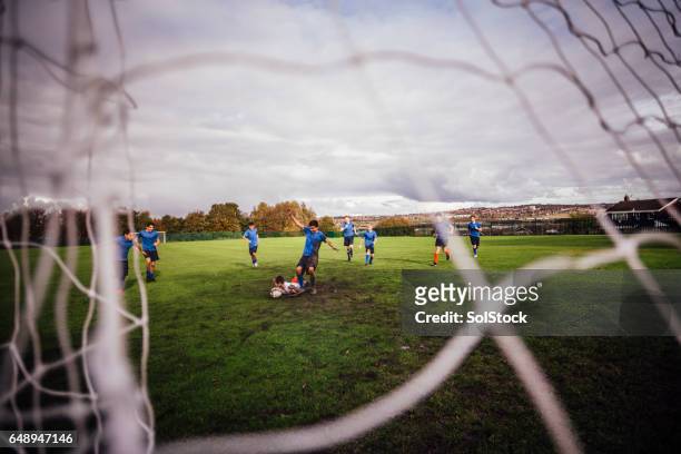 goalie player tackled down - tackling stock pictures, royalty-free photos & images