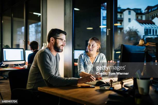 creative new business people working late on a computer - working late stock pictures, royalty-free photos & images
