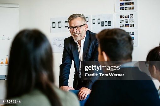 Mature businessman speaking in an informal meeting Mature businessman speaking in an informal meeting