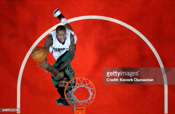 Jamal Crawford of the Los Angeles Clippers scores a basket against Amir Johnson of the Boston Celtics during the secone half of the basketball game...