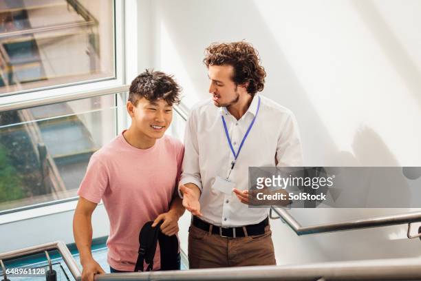 walking up school staircase together - chinese ethnicity stock pictures, royalty-free photos & images
