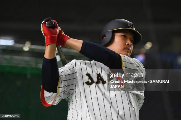 Outfielder Yoshitomo Tsutsugoh of Japan warms up prior to the World Baseball Classic Pool B Game One between Cuba and Japan at Tokyo Dome on March 7,...