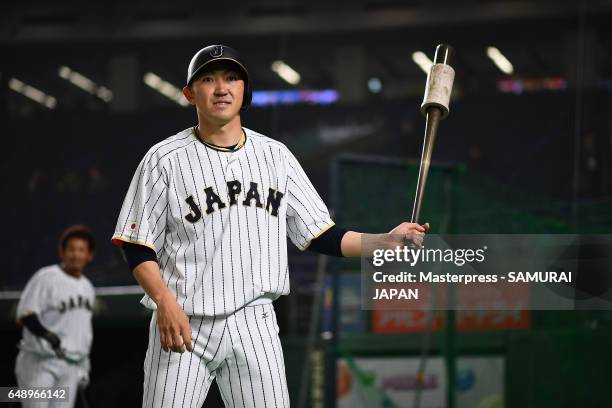 Outfielder Seiichi Uchikawa of Japan warms up prior to the World Baseball Classic Pool B Game One between Cuba and Japan at Tokyo Dome on March 7,...