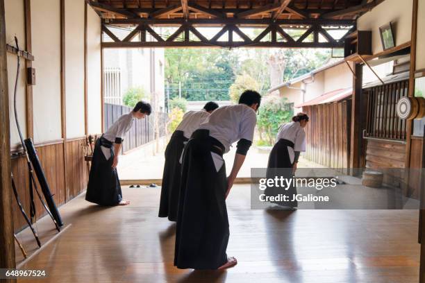 team of archers bow to show their respect - japanese martial arts stock pictures, royalty-free photos & images