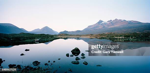 cuillin mountain range reflected in a loch - cuillins stockfoto's en -beelden