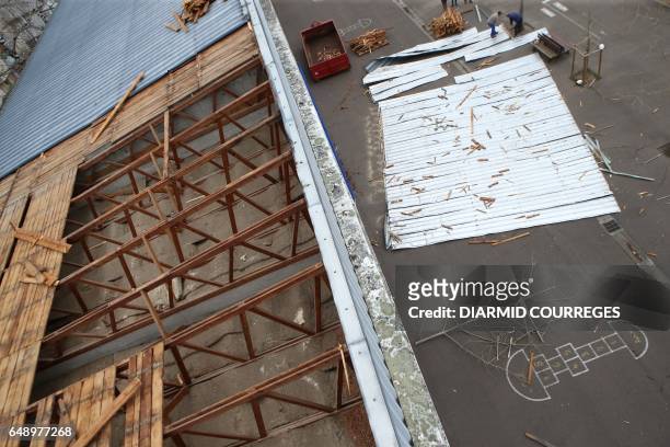 Metal roofing sheets are pictured in the courtyard of the Therese Simonet elementary school on March 7, 2017 in Brive-la-Gaillarde, a day after its...
