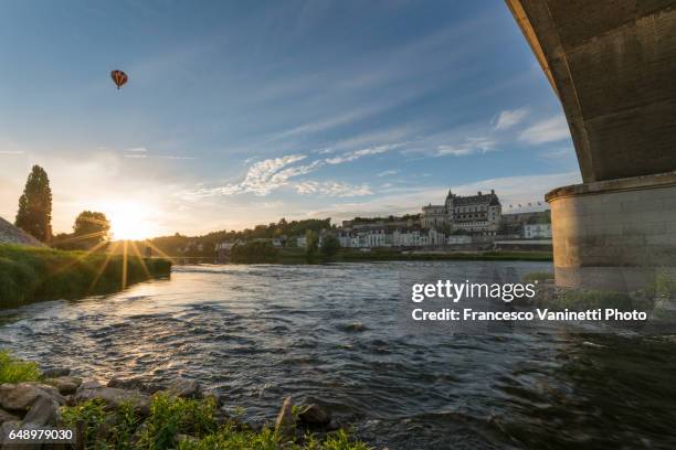 amboise with a hot-air balloon in the sky from under the bridge. - indre et loire stock pictures, royalty-free photos & images