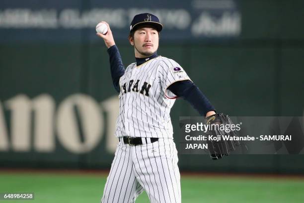 Starting pitcher Ayumu Ishikawa of Japan warms up prior to the World Baseball Classic Pool B Game One between Cuba and Japan at Tokyo Dome on March...