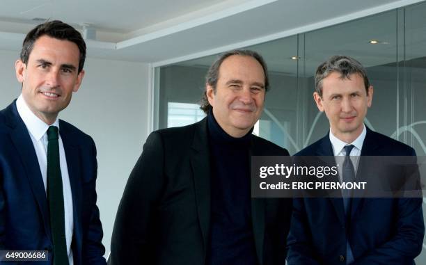 Of French telecom group Iliad Maxime Lombardini , Iliad Group founder and Vice President Xavier Niel and CFO Thomas Reynaud pose prior to a press...