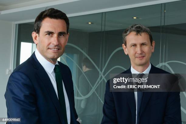 Of French telecom group Iliad Maxime Lombardini and CFO Thomas Reynaud pose prior to a press conference to present the group's 2016 results on March...