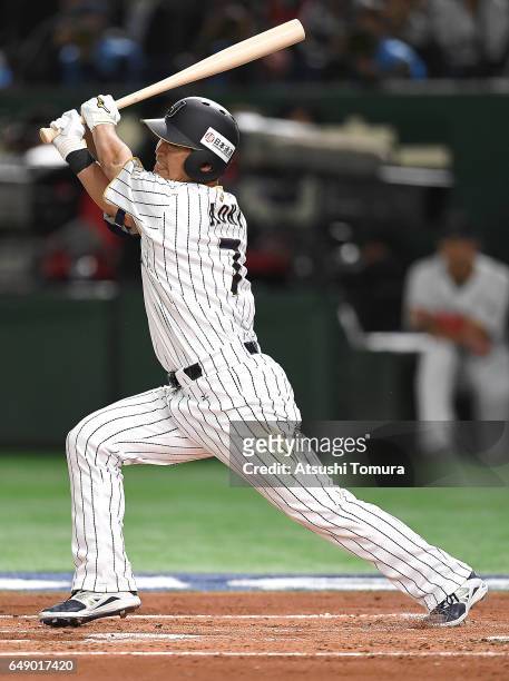 Norichika Aoki of Japan hits a double in the first inning of the World Baseball Classic Pool B Game One between Cuba and Japan at Tokyo Dome on March...