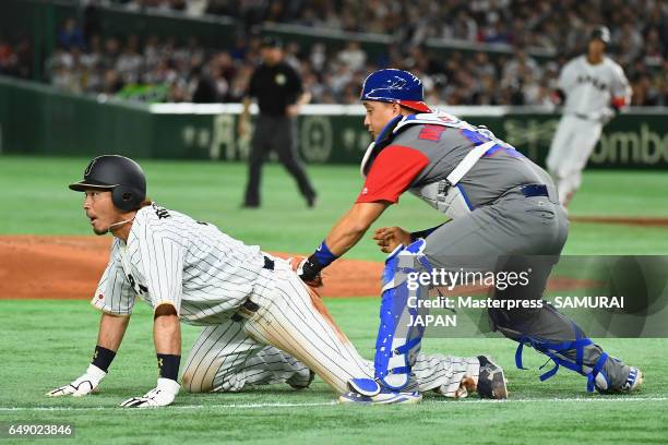 Infielder Nobuhiro Matsuda of Japan is tagged out by Catcher Frank Morejon of Cuba in the bottom of the second inning during the World Baseball...