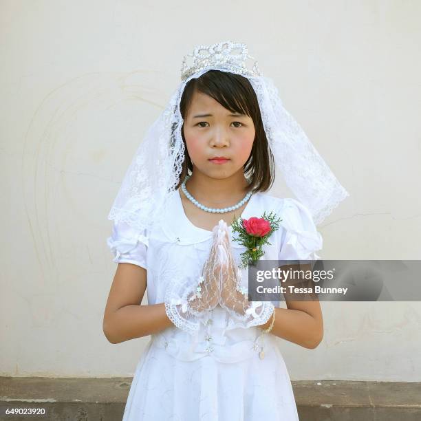 Portrait of an ethnic Kayah girl at her first communion at Christ the King Cathedral in Loikaw, Kayah State, Myanmar on 20th November 2016. In the...