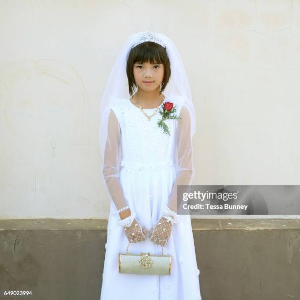 Portrait of Innocent, a ten year old ethnic Kayan girl at her first communion at Christ the King Cathedral in Loikaw, Kayah State, Myanmar on 20th...