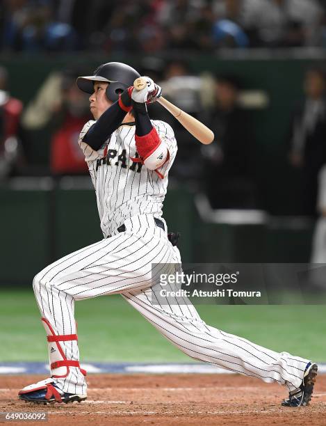 Tetsuto Yamada of Japan hits a RBI double to make it 1-2 in the fourth inning of the World Baseball Classic Pool B Game One between Cuba and Japan at...