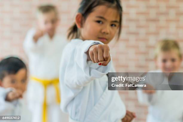 punching in class - girl martial arts stock pictures, royalty-free photos & images