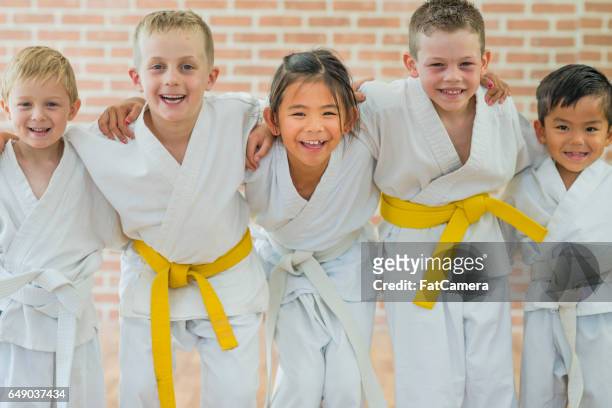 getting a yellow belt - martial arts stock pictures, royalty-free photos & images