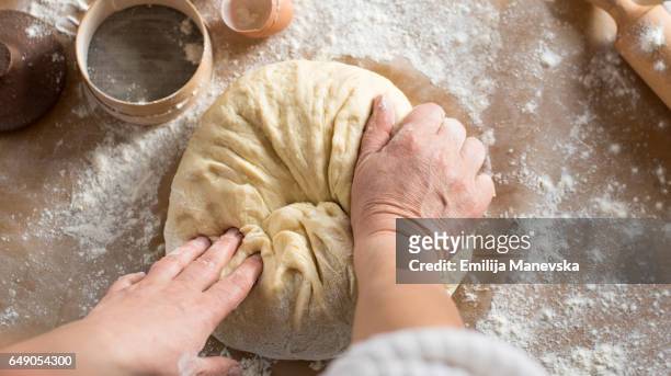 woman kneading dough in kitchen - knåda bildbanksfoton och bilder