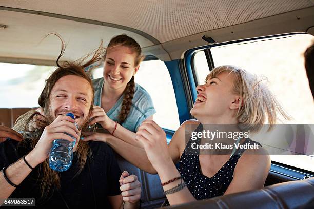 friends laughing together inside car - friends inside car imagens e fotografias de stock