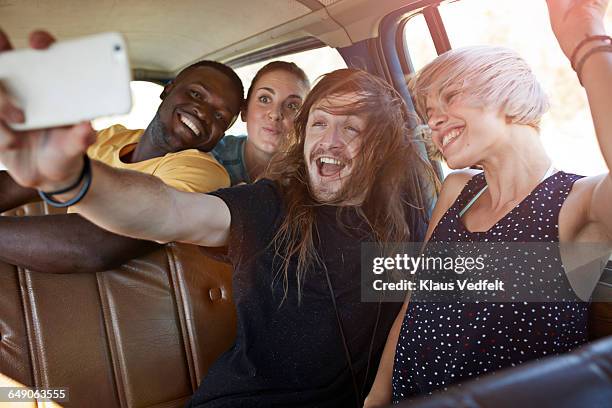 friends making selfie while riding car - human mouth stock photos et images de collection