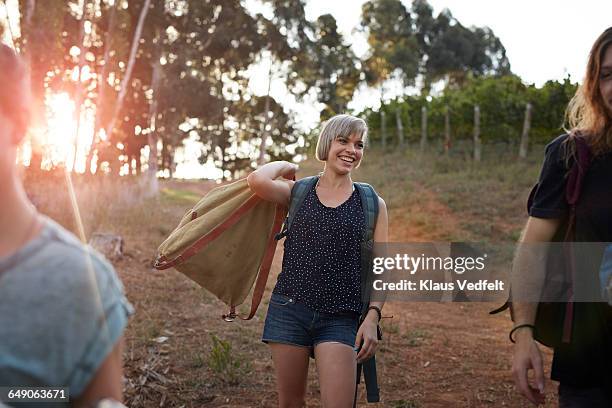 friends walking with backpacks on camping trip - short shorts stock pictures, royalty-free photos & images