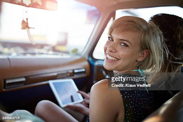 portrait of woman laughing to camera - two cars side by side stock pictures, royalty-free photos & images