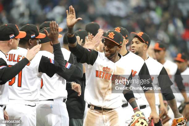 Jurickson Profar of the Netherlands celebrates with his teammates after winning the World Baseball Classic Pool A Game Three between South Korea and...