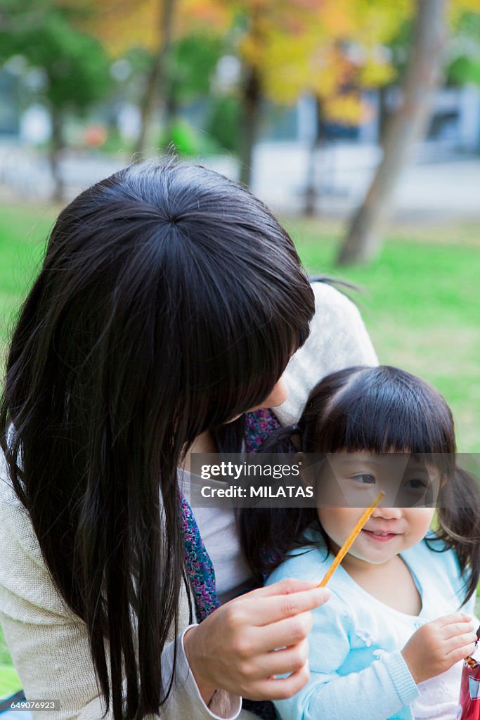 Japanese mother and daughter eating sweets