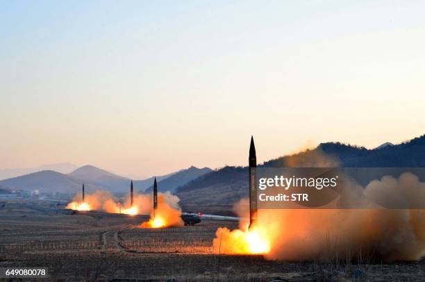 This undated picture released by North Korea's Korean Central News Agency via KNS on March 7, 2017 shows the launch of four ballistic missiles by the...