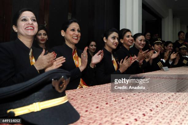 Indian female pilots of Air India, the country's state owned carrier, are seen after their ceremony on the eve of international women's day, in New...