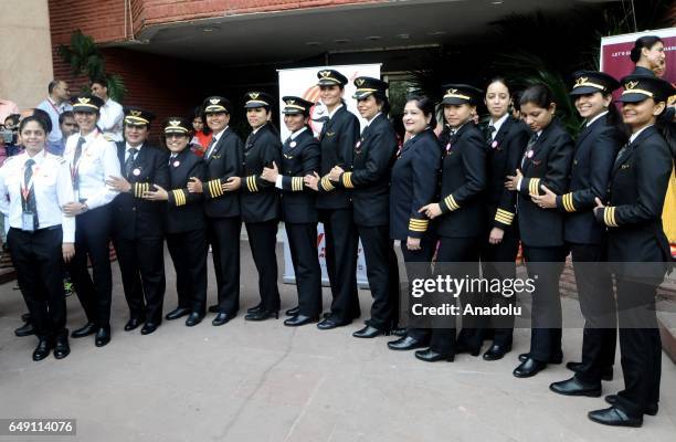 Indian female pilots of Air India, the country's state owned carrier, pose for a photograph after their ceremony on the eve of international women's...