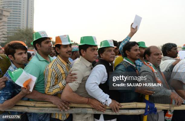 India's Congress Party workers and supporters wait for a speech by the party's vice-president Rahul Gandhi at a rally in New Delhi on March 7 ahead...