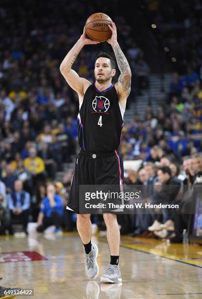 Redick of the LA Clippers looks to pass the ball against the Golden State Warriors during an NBA basketball game at ORACLE Arena on February 23, 2017...