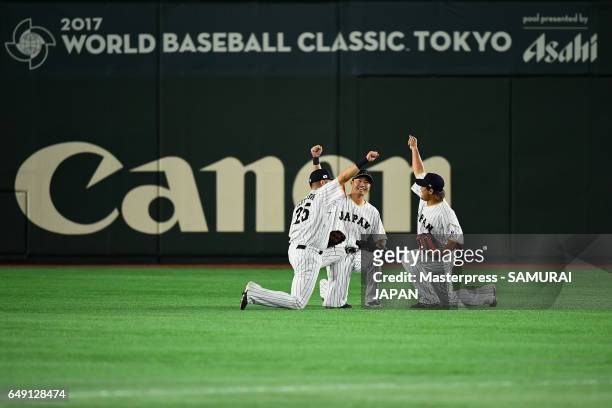 Outfielders Yoshitomo Tsutsugoh, Outfielder Norichika Aoki, Outfielder Ryosuke Hirata of Japan celebrate their win in the World Baseball Classic Pool...