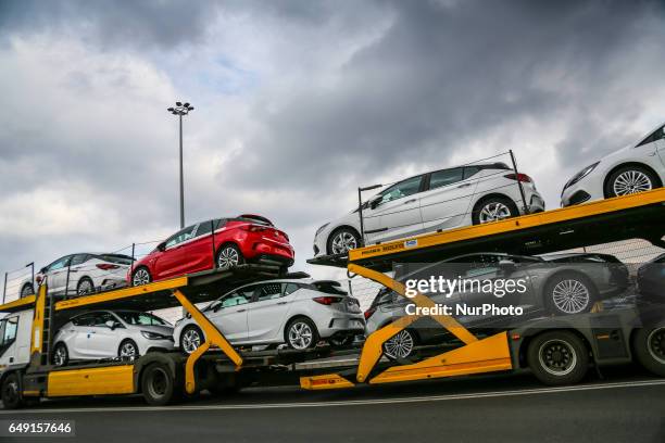 Brand new Opel Astra vehicles are transported by a car carrier trailer as they leave the Opel car factory of General Motors Manufacturing Poland in...