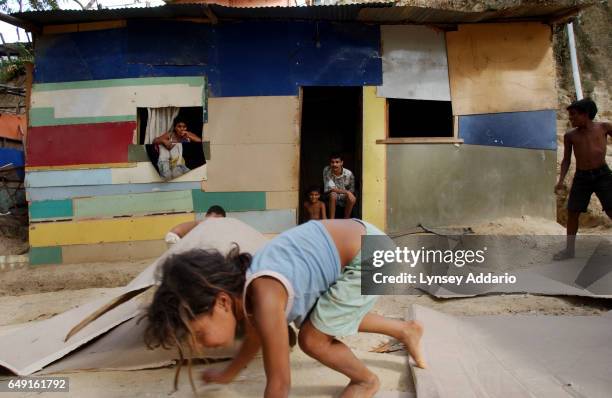 Poor children play in the streets of Las Mayas, a shantytown in the hills surrounding Caracas, Miranda, Venezuela on May 2, 2002. Since the start of...