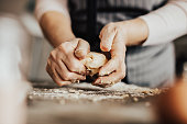 Close-up of woman's hands kneading dough