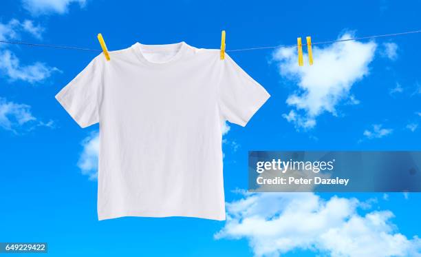 white tee shirt on washing line - hanging clothes stock-fotos und bilder