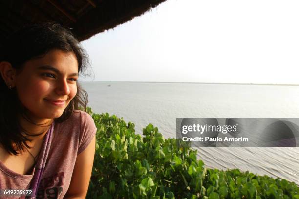 a youg girl enjoying the view at amazon in brazil - amazon jungle girl stock-fotos und bilder