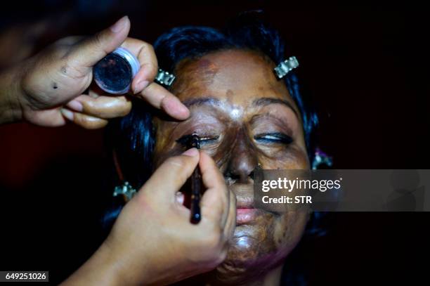 Bangladeshi acid attack survivor has her makeup done backstage prior to the fashion show "Beauty Redefined" by designer Bibi Russell, featuring acid...