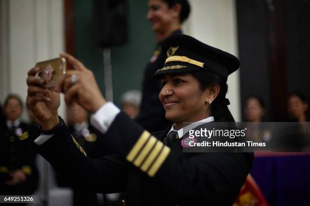 Female pilot of Air India take pictures of another colleague during the celebration ceremony of all women crew of their airlines on the eve of...